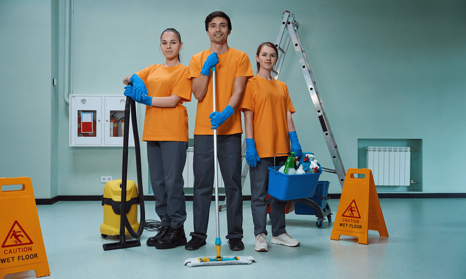 Cleaning crew with equipment and caution signs.