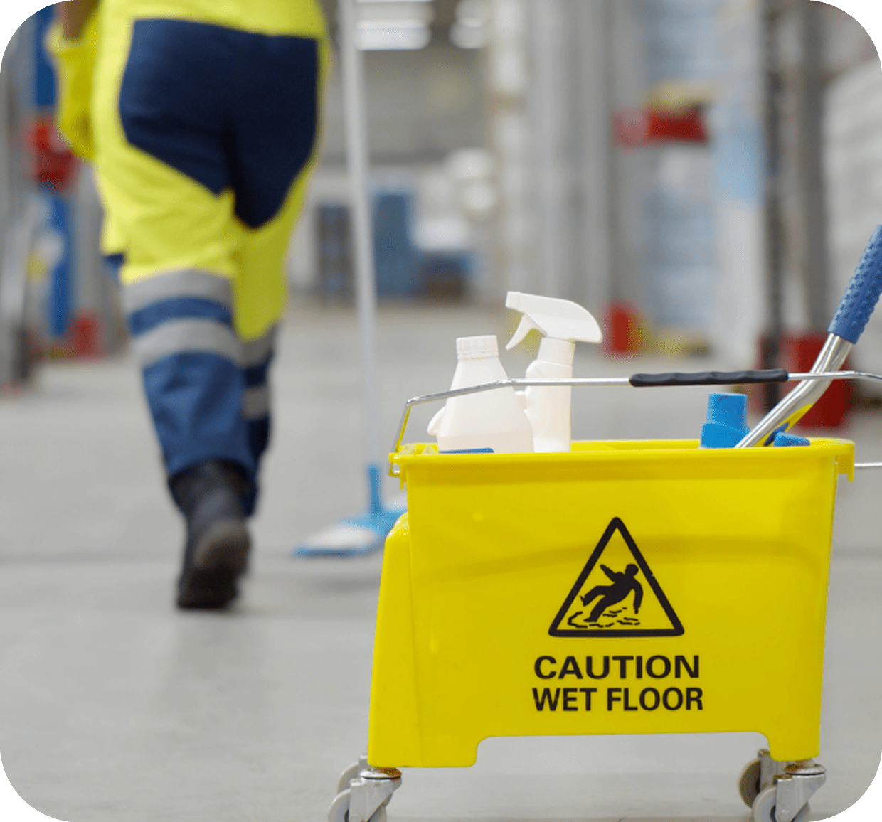 Yellow caution sign with cleaning supplies nearby.